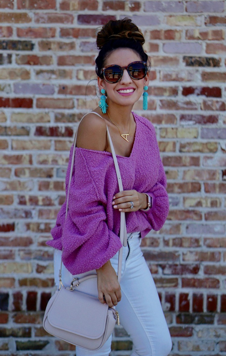 Big tortious shell sunglasses, Orchid colored drop shoulder slouchy sweater, and white denim