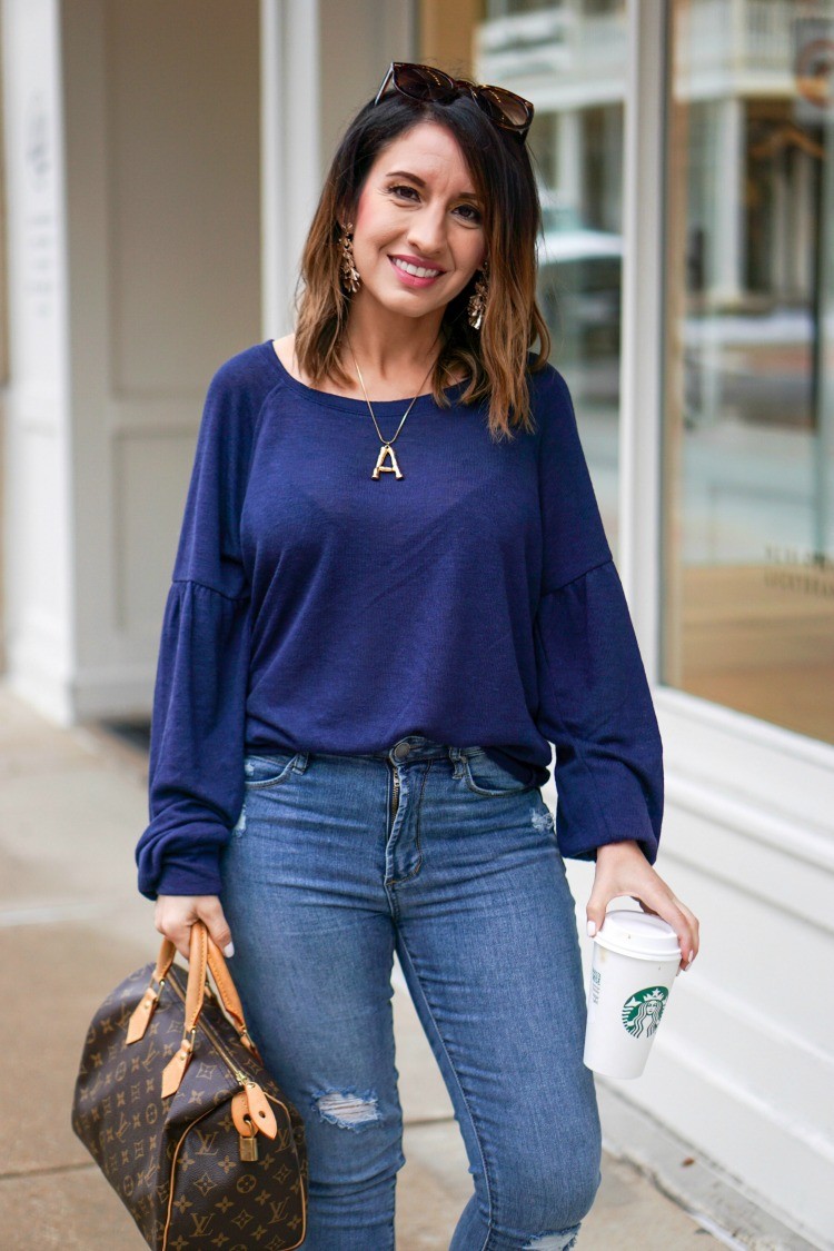 Blue sweater, blue jeans, and sunglasses