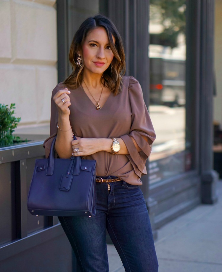 Sassy blouse, leopard belt, and dark skinny jeans