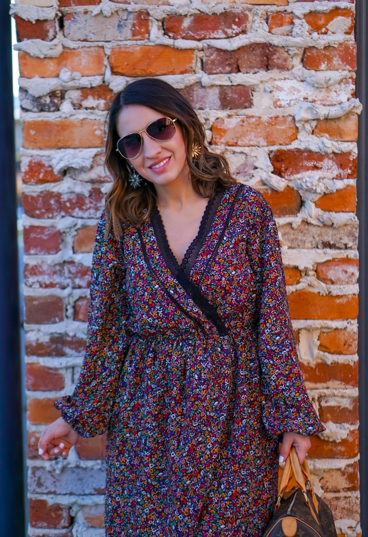 Sunglasses, floral wrap dress, and statement earrings