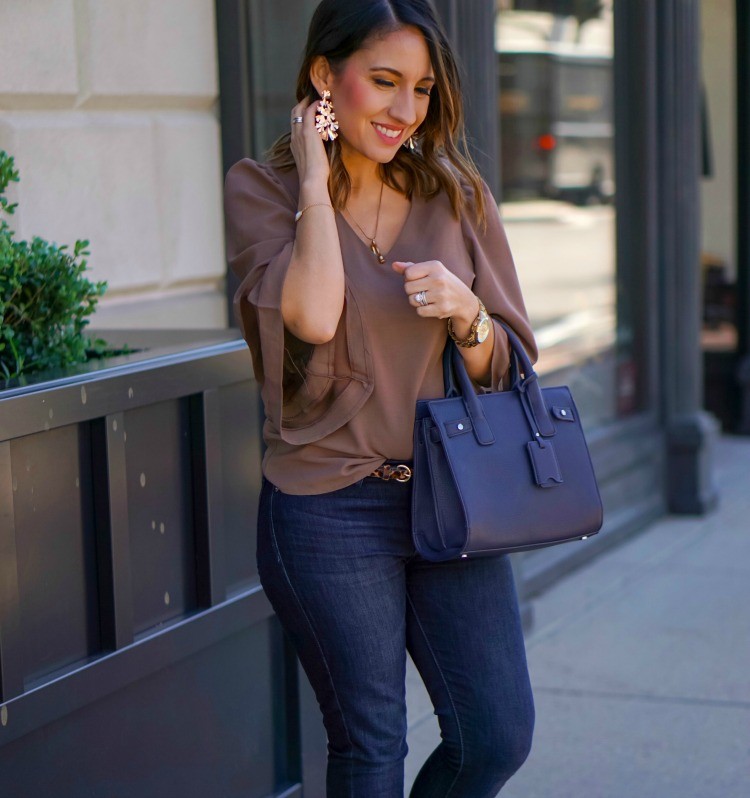 Taupe blouse, dark skinny jeans, and Stella and Ruby statement earrings