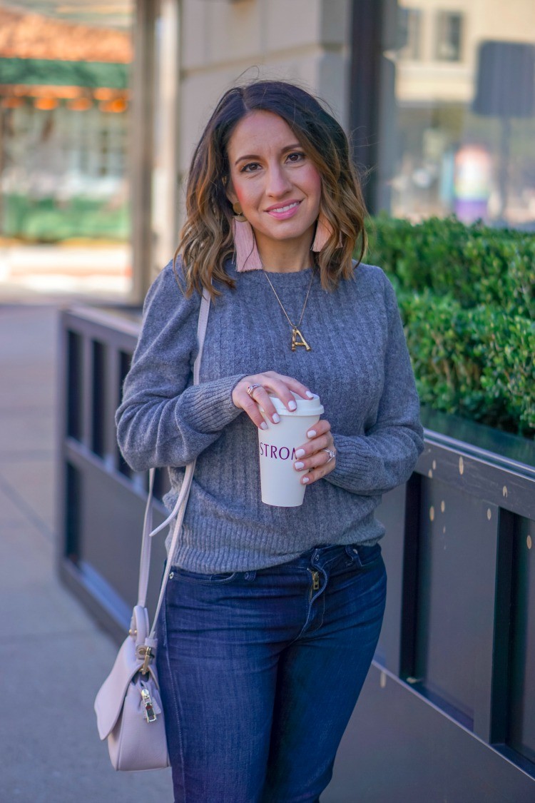 Statement earrings, ribbed sweater, and jeans