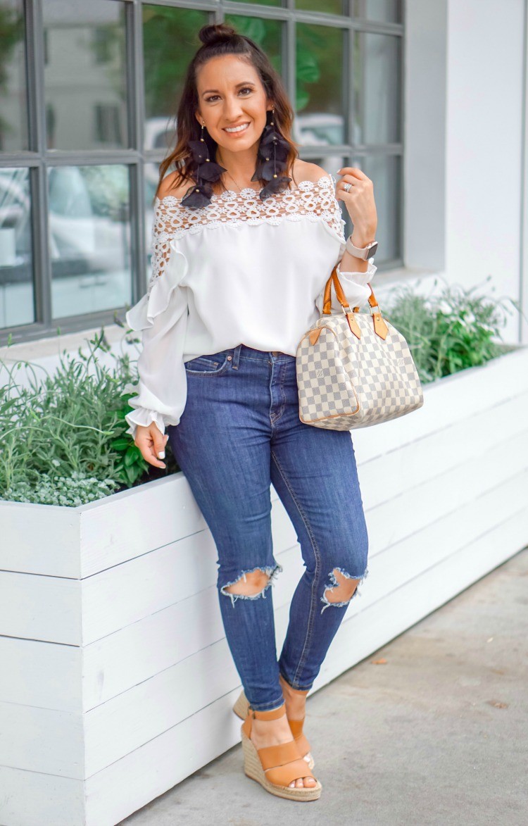 White off the shoulder blouse, skinny jeans, statement earrings, and wedges